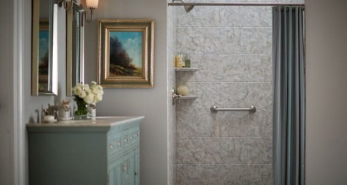 Modern bathroom with gray walls, a walk-in shower, and green vanity.
